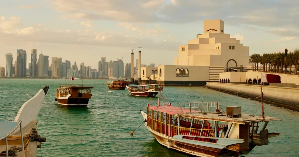 The Museum of Islamic Art in Doha with traditional dhow boats on the Corniche waterfront