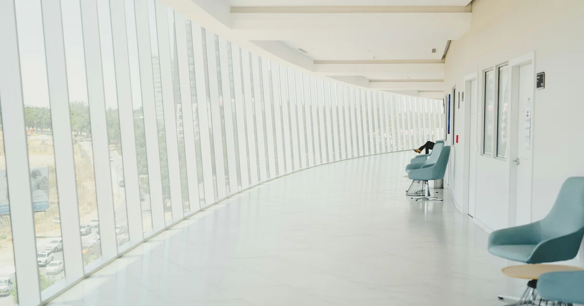 A bright, modern hospital corridor and waiting area in Qatar