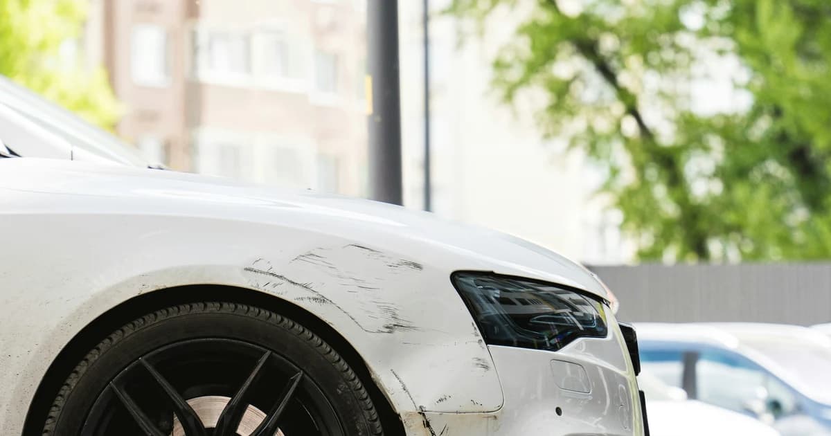 Close-up of scratch damage on a car fender after a minor collision