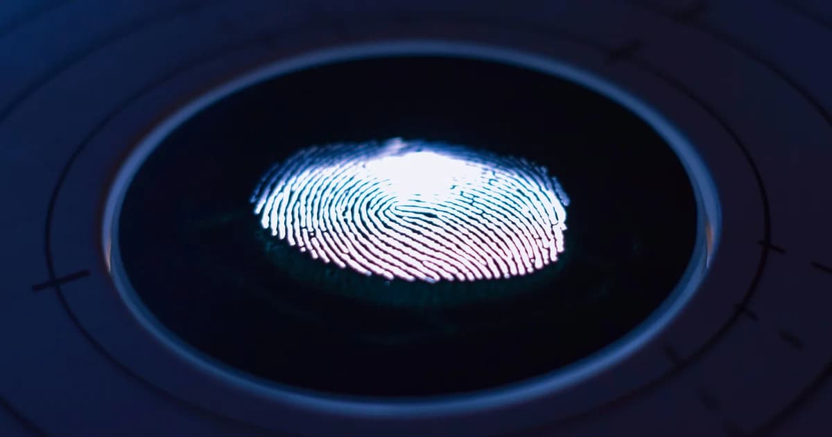 Fingerprint scan on a glowing biometric enrollment scanner