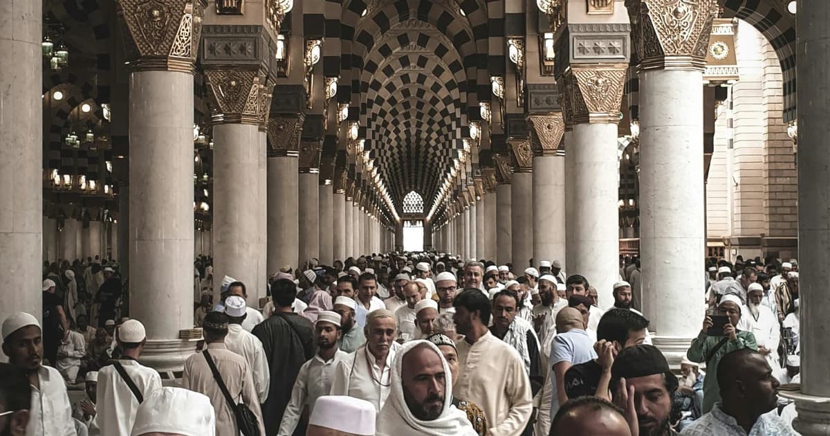 Pilgrims walking through the mosque in Madinah during their Umrah journey
