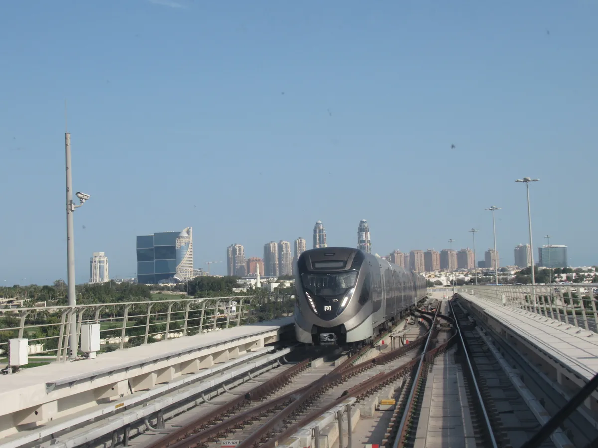Doha Metro Red Line train on elevated track, the line serving Qatar University station