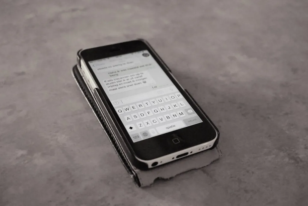 A smartphone on a table showing a text message screen