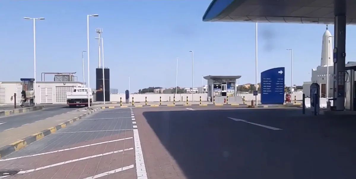 WOQOD petrol station forecourt in Jeryan Jenaihat, Doha, with its blue WOQOD sign