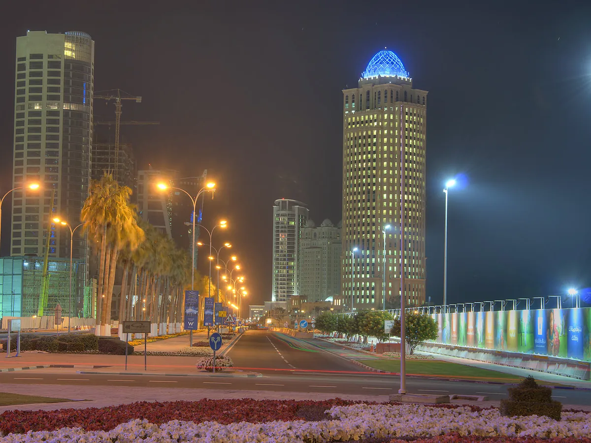 Ooredoo tower, formerly QTel Tower, lit at night on Diplomatic Street in West Bay, Doha