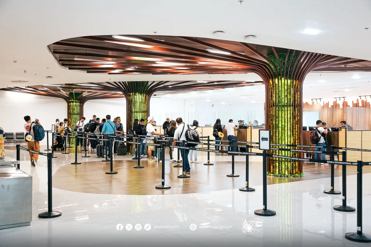 Passengers queuing at passport control in Ninoy Aquino International Airport Terminal 3 in Manila, where departing OFWs present an OEC or OFW Pass